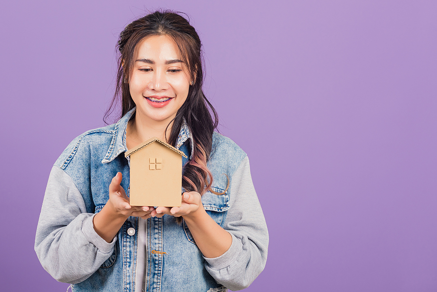 Woman Holding Tiny Home Address Scoop